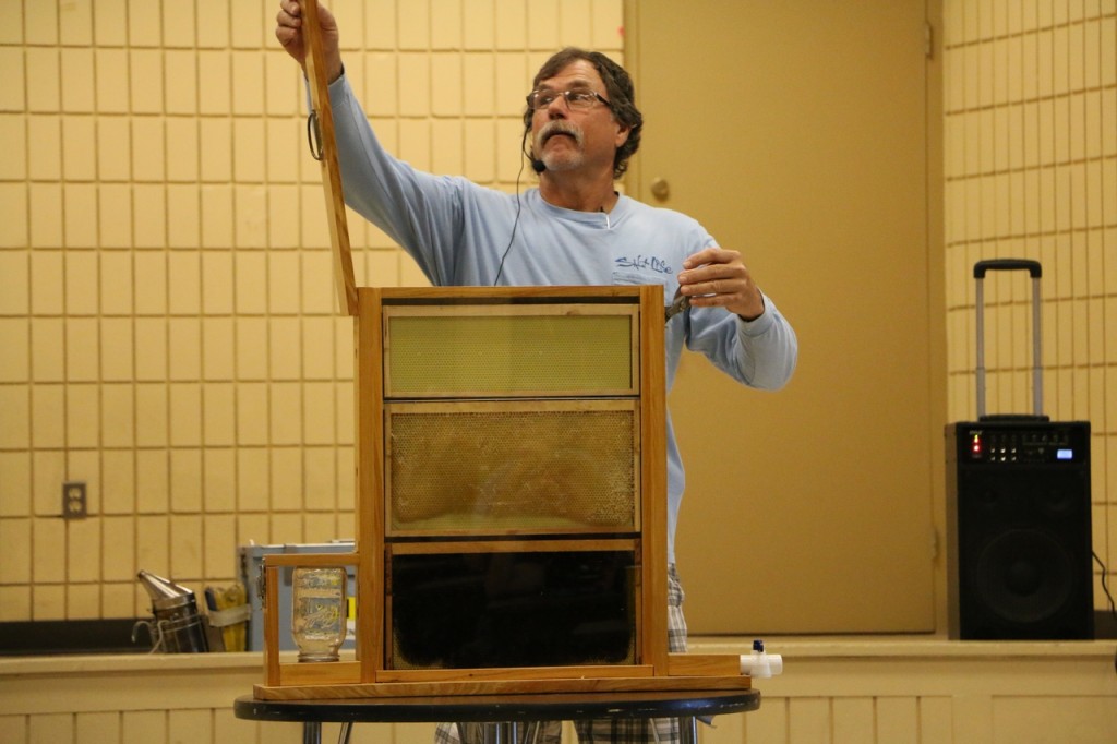 Larry Hirt showing the observation hive that he designed and built, June 2015 (Stephen Clay McGehee)